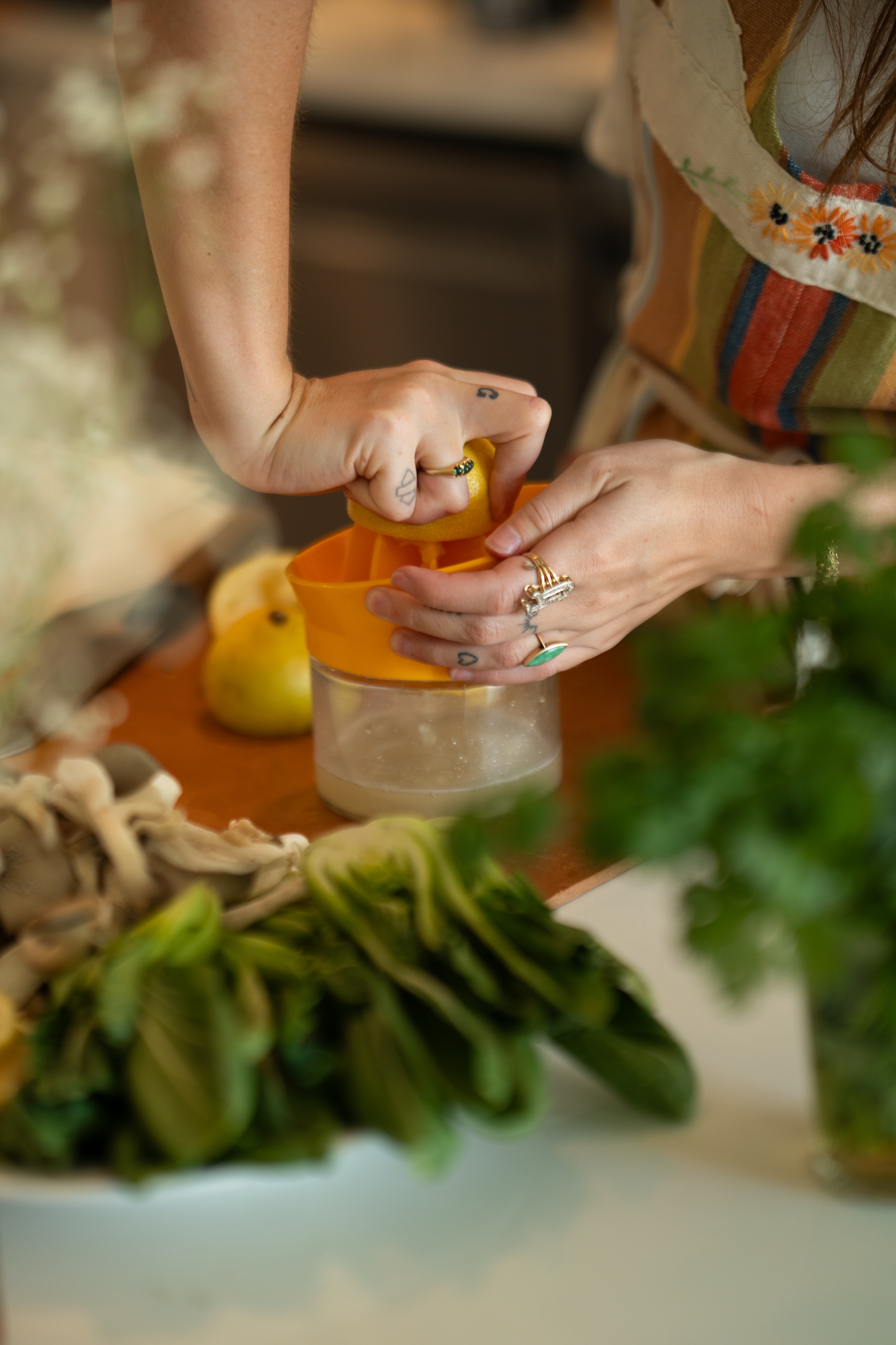 Hands juicing a lemon in the kitchen
